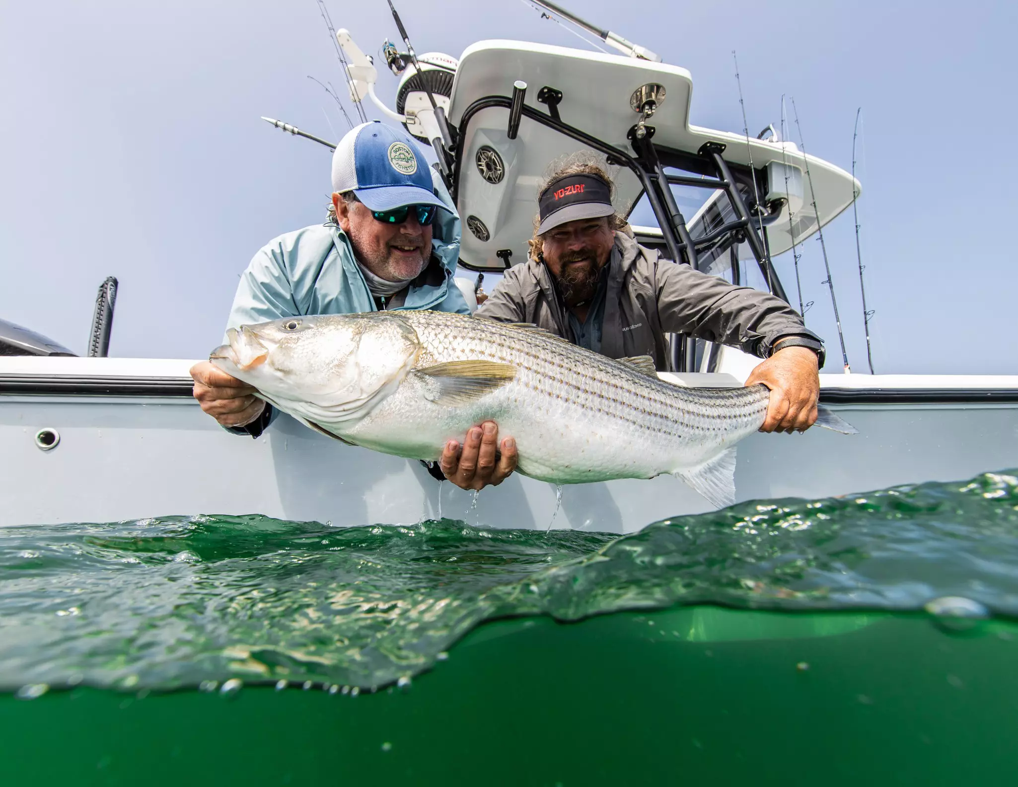 Carter Andrews posing with a striped bass