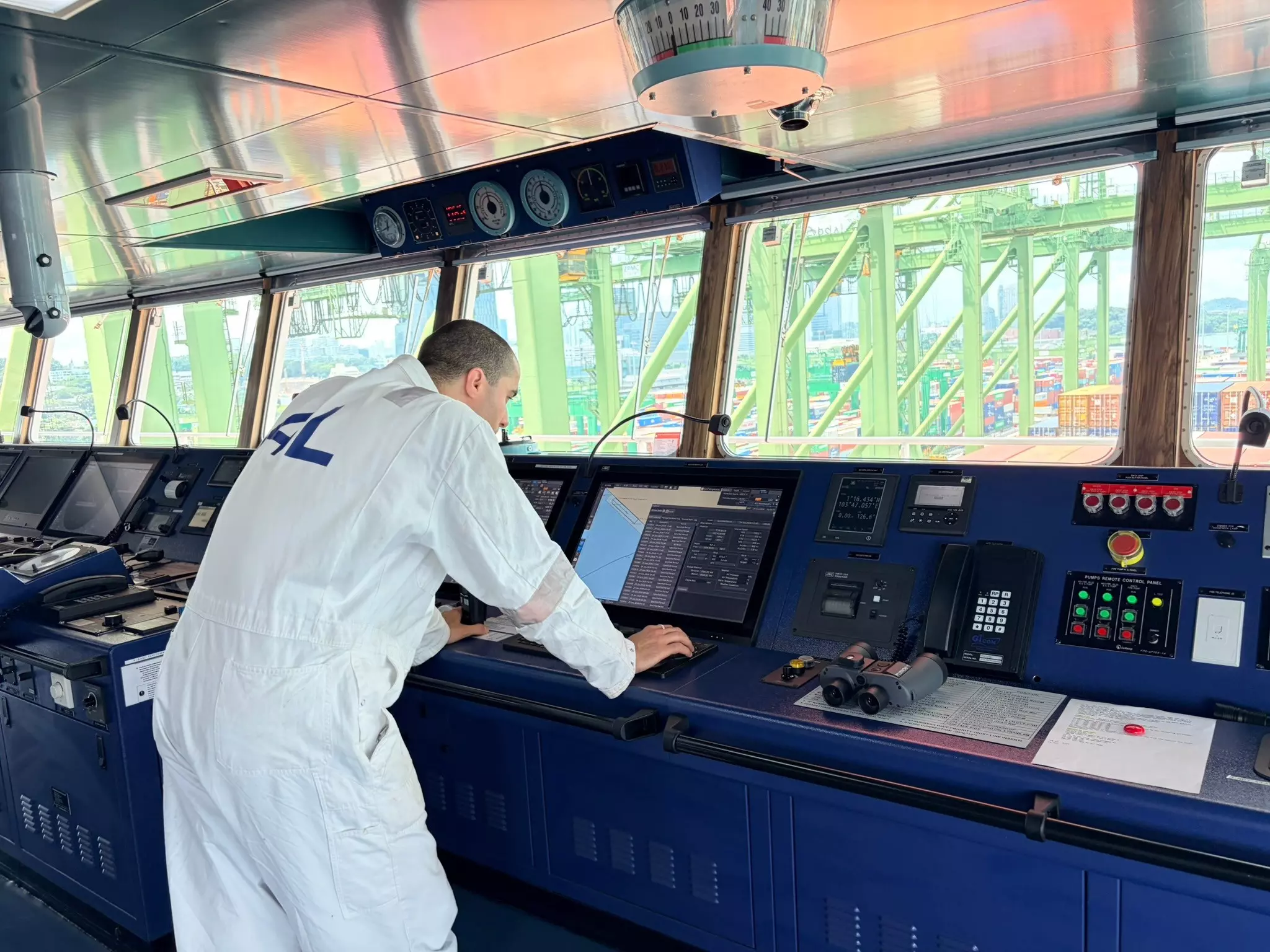 Luka Milidrag looking at an ECDIS on the bridge of the MV ALS FIDES