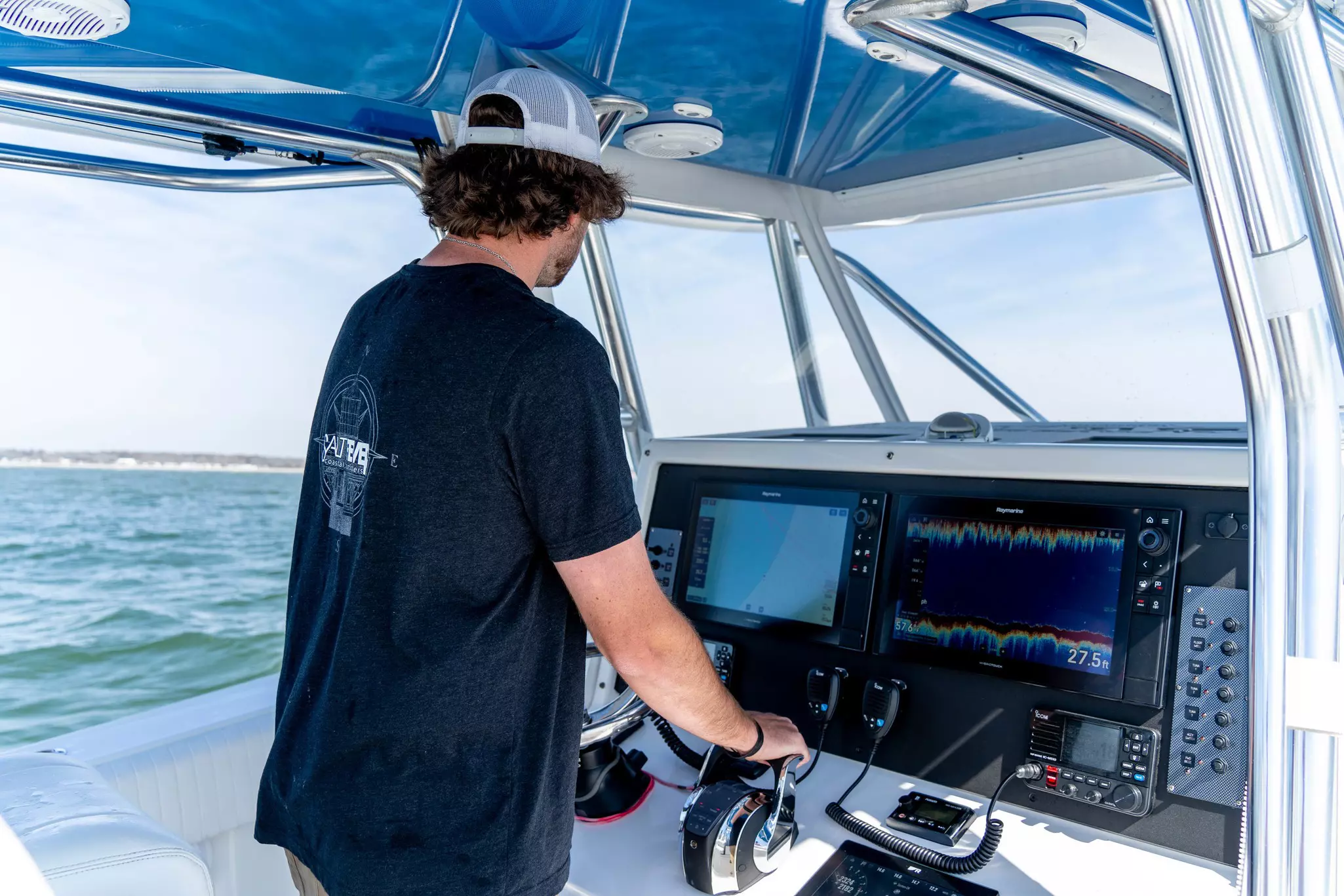 Modern Raymarine Axiom XL helm on center console boat