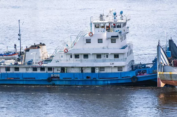 A tugboat pushes a large barge with cargo along a wide river. In summer, the tugboat goes down the river. Cargo transportation by river. Navigation of vessels on the river.
2272428771
Inland river tugs