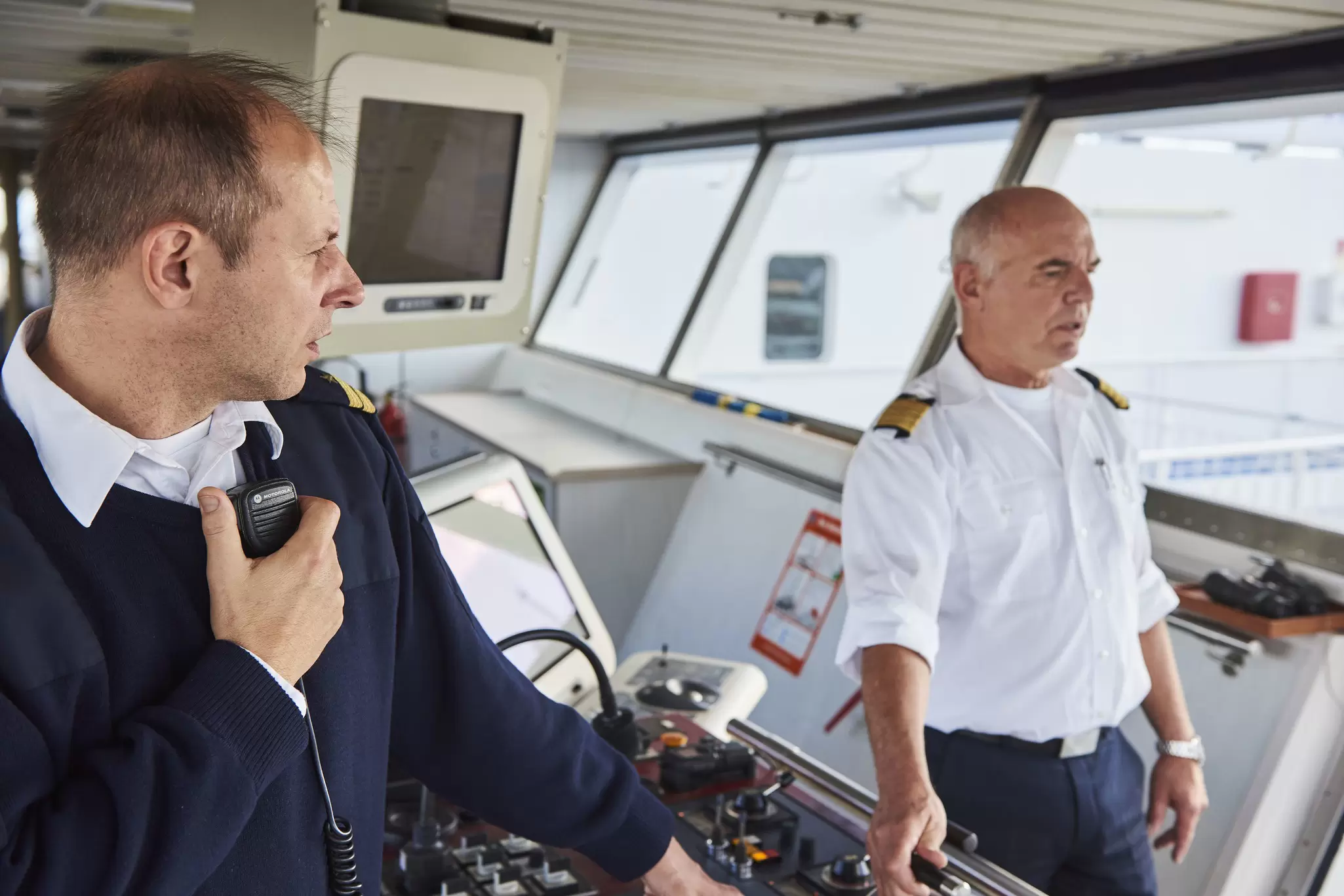 Image of a captain and office on the bridge of a commercial vessel.