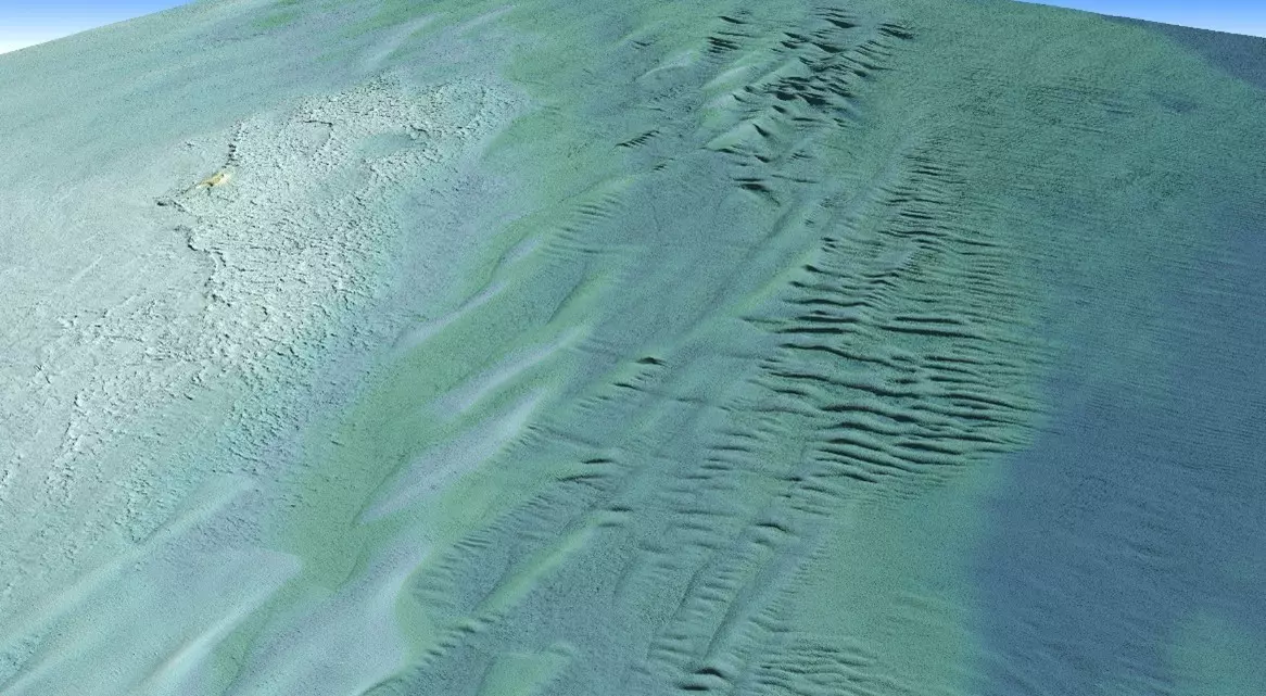 An oblique view of a Digital Elevation Model (DEM) derived from topobathymetric lidar collected by Tetra Tech's CZMIL SuperNova. This view is looking northwest across Lake Superior towards Tahquamenon Island in Whitefish Bay.