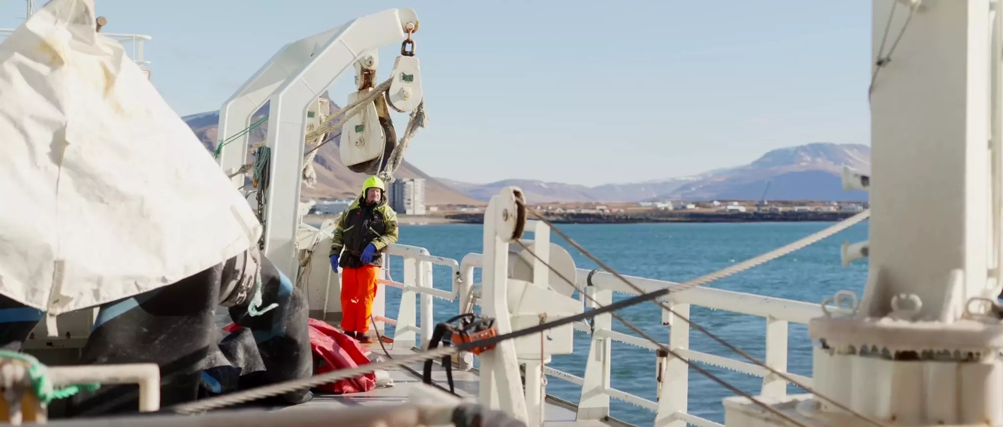 Crew member stood on deck of a commercial fishing vessel